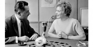 A man and woman having a conversation for a radio show.